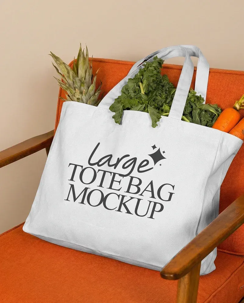 Large tote bag mockup filled with groceries on a chair